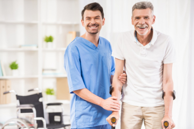 senior man and caregiver smiling