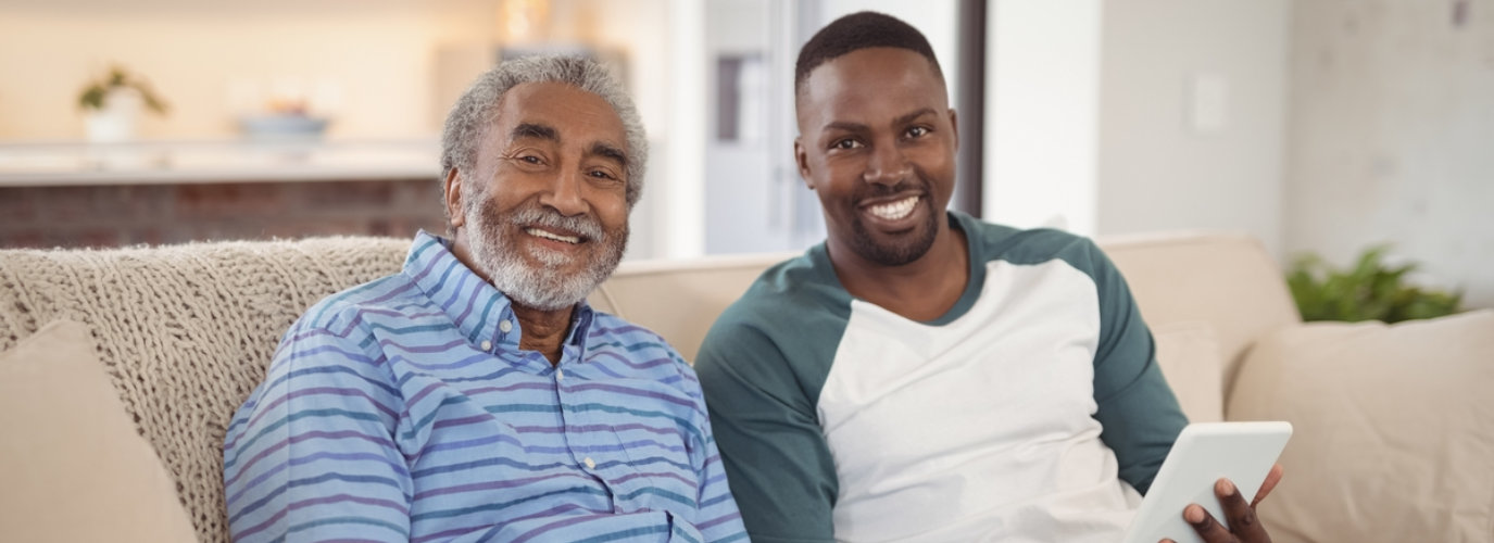 adult man and senior man smiling